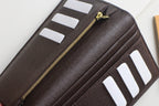 Louis Vuitton small wallet with gold zipper and card slot pockets in dark leather