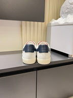 YSL unisex sneakers, rear view in white with navy heel tab and red collar detail