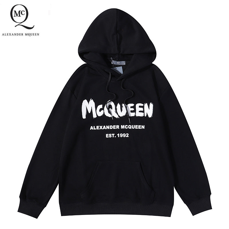 Black pullover hoodie with McQueen lettering and Alexander McQueen logo on chest.