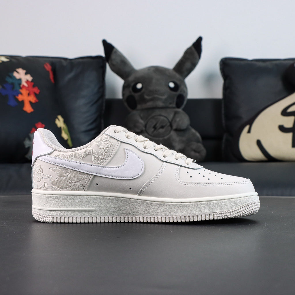 White Air Force 1 low sneakers with textured panels, Nike swoosh, and lace-up