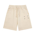 Light beige Maison Margiela shorts with elastic waistband, drawstring, and dash graphic.