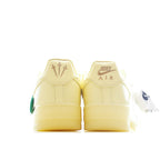 Air Force 1 low-top sneaker heel view in pale yellow leather with gold logo detail