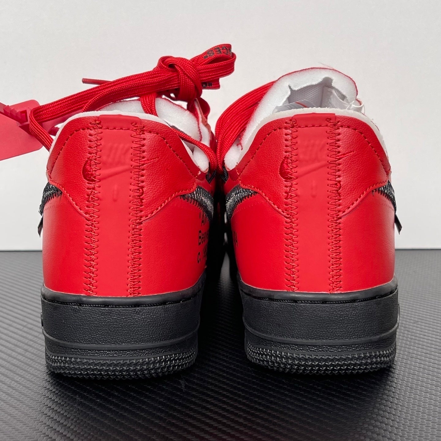 Red leather low-top sneakers, black heel panel, red laces, white interior