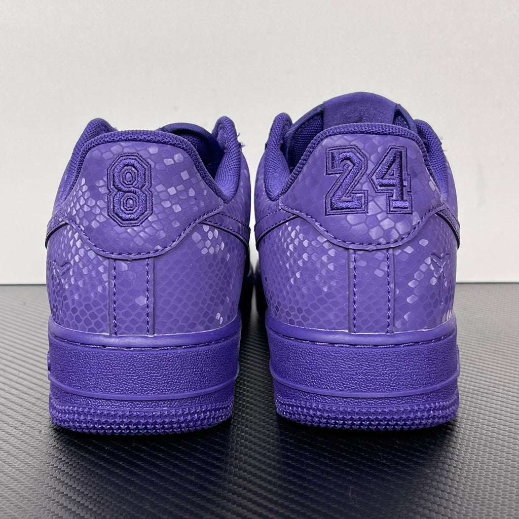 Purple low-top sneakers with lace-up closure and “24” heel detail