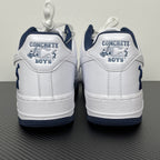 White Nike Air Force 1 heel with navy trim and “CONCRETE BOYS” text patch