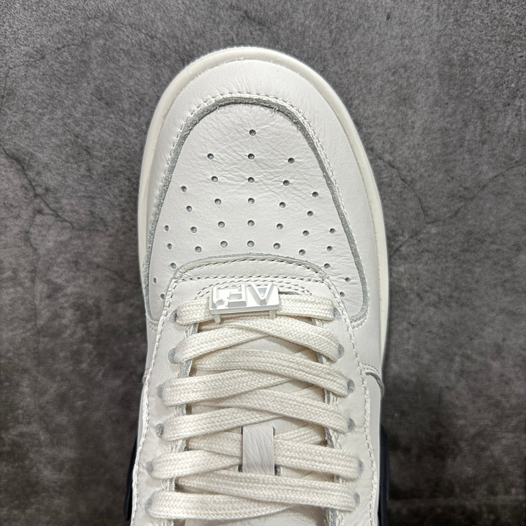 White leather sneaker with lace-up vamp and perforated toe box