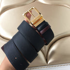 Leather belt with gold buckle and layered strap ends