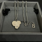Heart and letter pendant necklaces with silver chains in gray gift box