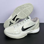 Low-top sneakers with textured outsole, white star upper, black swoosh, white laces