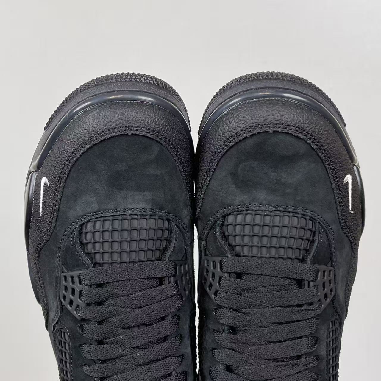 Air Jordan 4 sneakers, dark gray suede with rear mesh cages and lace-up eyelets