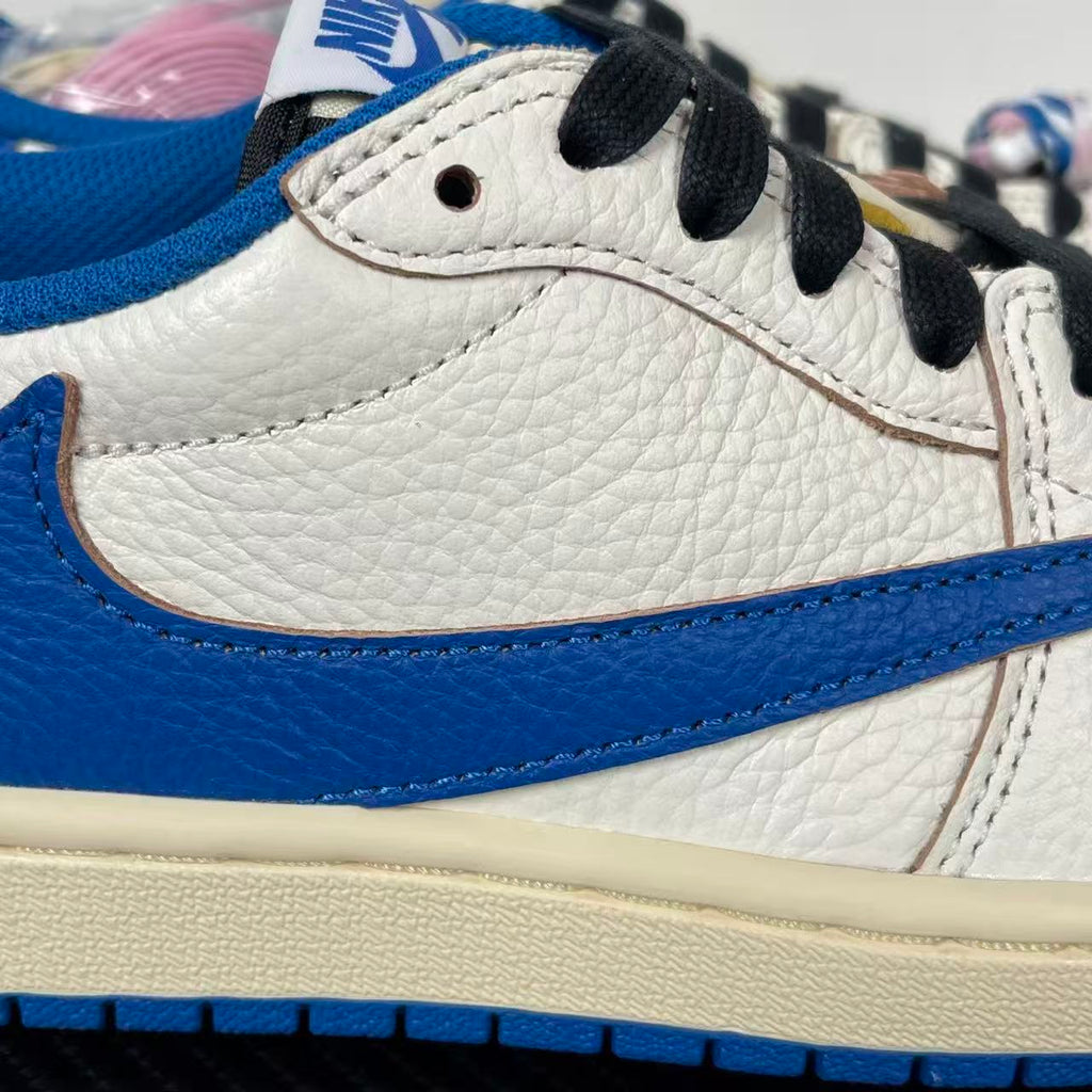 Close-up of white and blue sneaker side with black lace, stitching, and textured panel