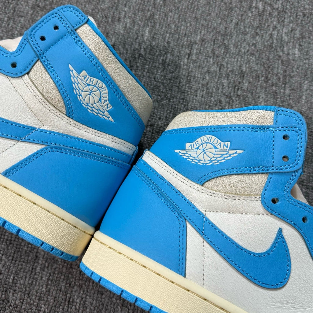 High-top sneakers with blue and white leather panels, blue swoosh, lace-up closure