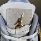 Back heel area of light blue Air Jordan 4 sneakers with gold Jumpman patch