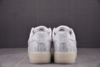 White low-top sneakers heel view with embossed text and lace-up detail