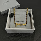 Balenciaga gold chain necklace in gift box with charm details and branded tag