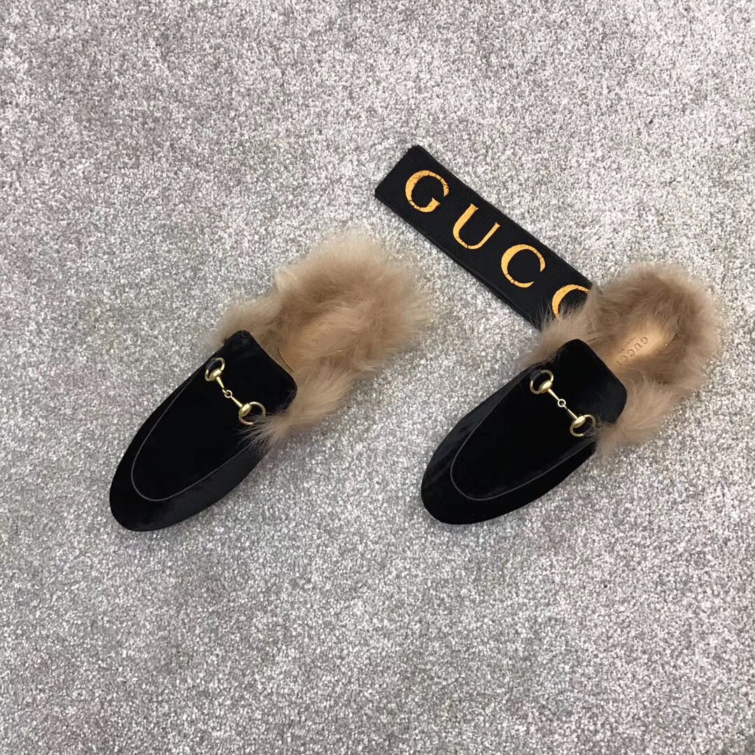 Black velvet loafers with beige faux fur trim and gold-tone ring bit hardware