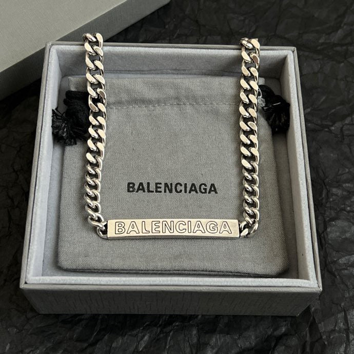 Balenciaga small chain-trim pouch bag with silver links and BALENCIAGA text