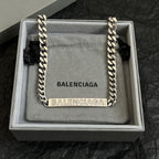 Balenciaga small chain-trim pouch bag with silver links and BALENCIAGA text