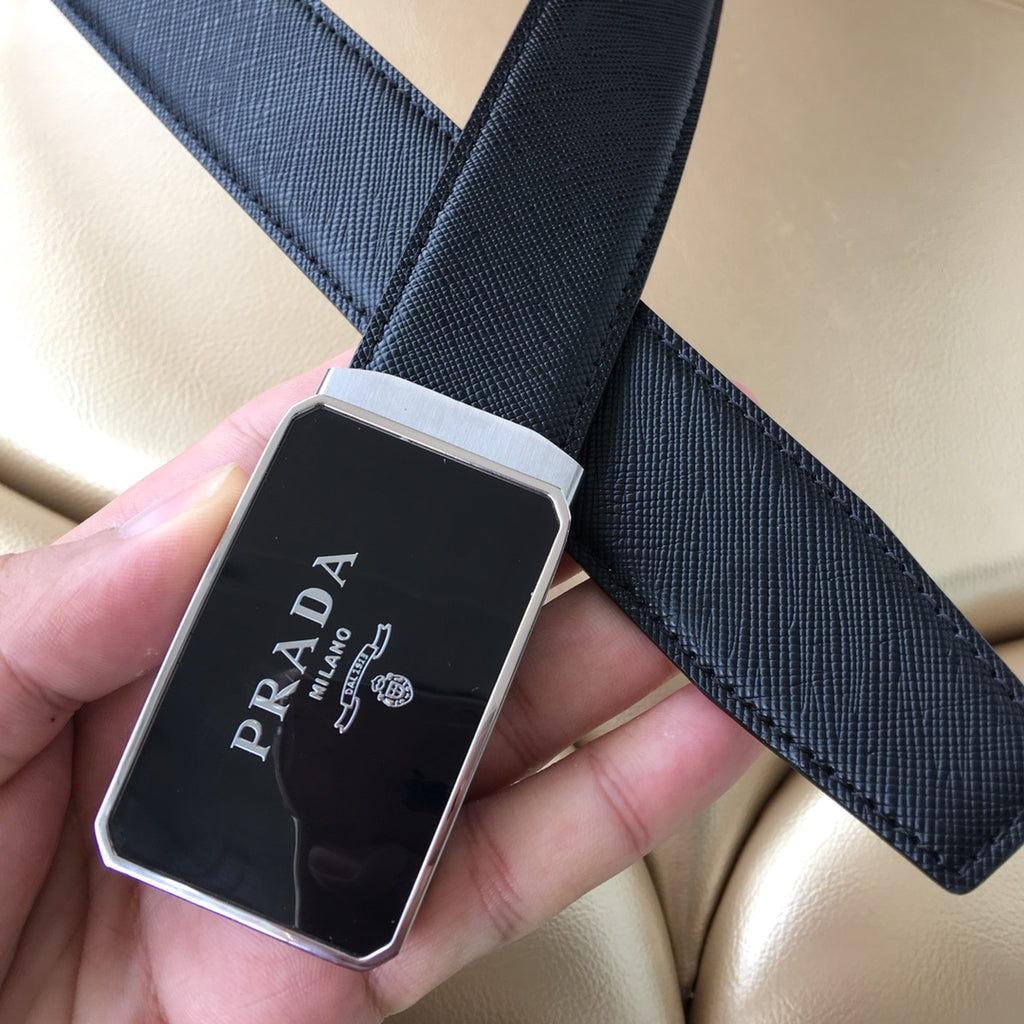 Close-up of dark textured leather belt with square Prada buckle