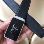 Close-up of dark textured leather belt with square Prada buckle