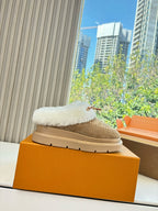 Louis Vuitton tan shearling loafer on orange box, white fur upper and sole