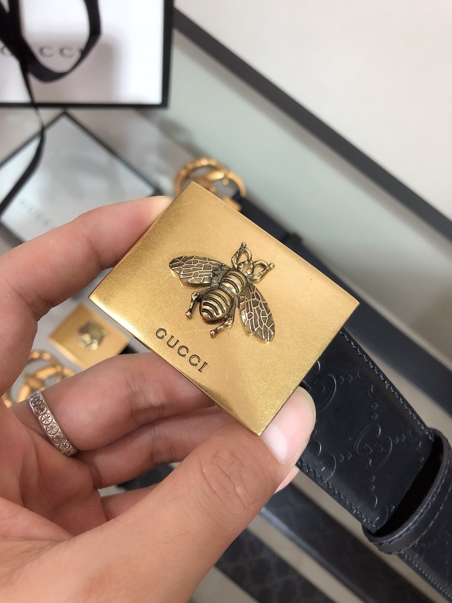 Belt with gold bee charm on black strap