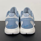 Pair of light blue and gray basketball shoes with white heel, padded back, lace-up.
