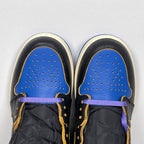 High-top sneakers toe view with perforated blue panels, black leather, purple lace, cream trim