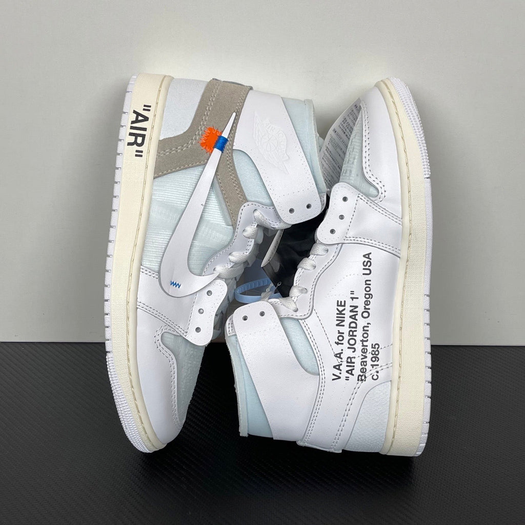 Pair of high-top sneakers angled view, white leather with light blue panels and tan-gray collar