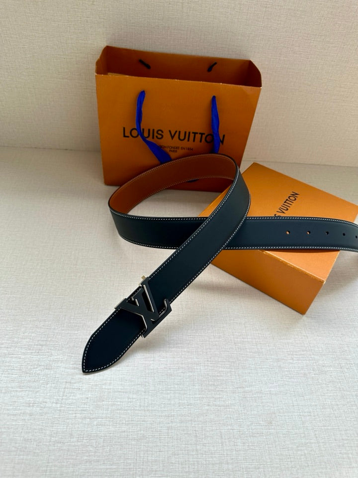 Louis Vuitton belt with dark blue strap, silver LV buckle, and tan inner edge