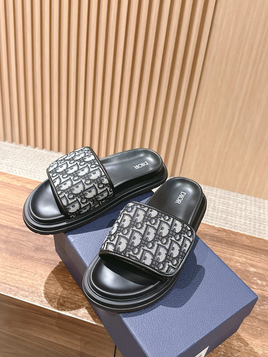 Dior slide sandals on blue box, black sole with Dior monogram adjustable-looking strap