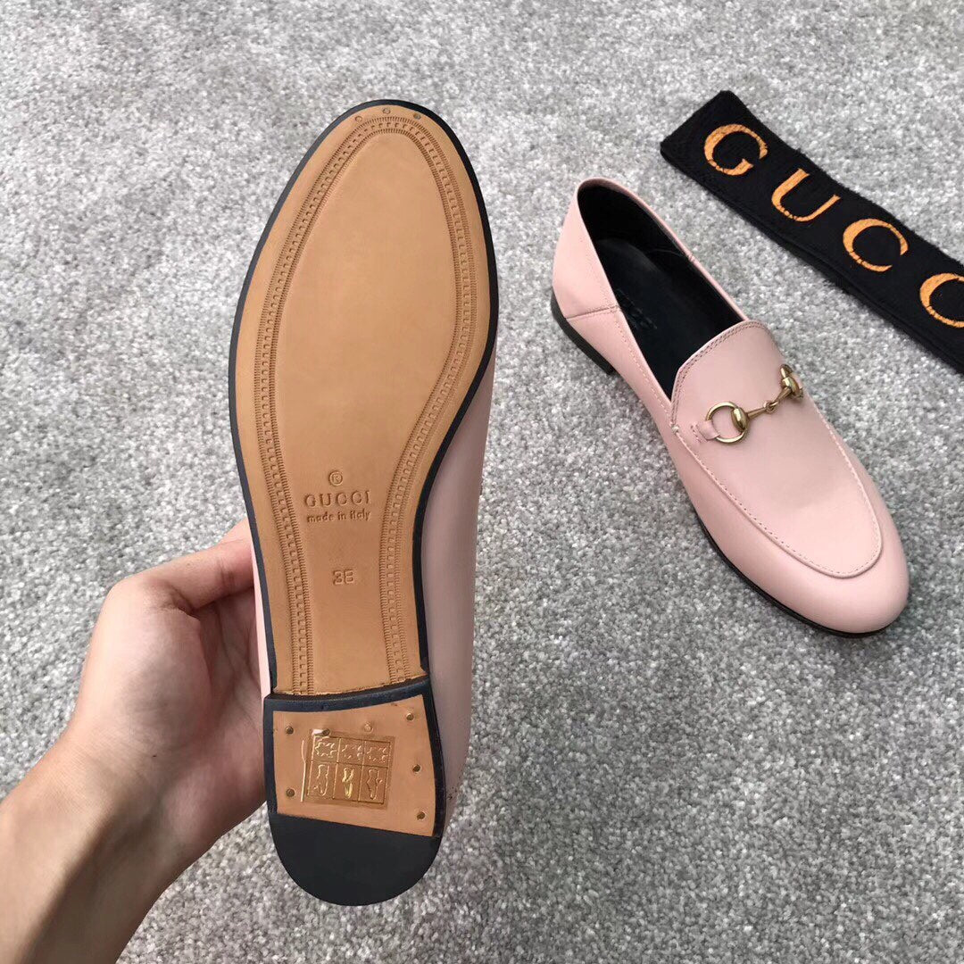 Gucci pink loafers outsole with leather sole and gold-tone hardware, underside view