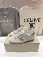 Golden Goose light gray sneakers with patterned laces and metallic star side detail