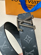 Louis Vuitton belt buckle detail on dark blue monogram strap with silver-tone stones