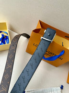 Blue and dark monogram belts with rectangular buckles and engraved logo straps