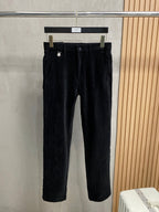 Black trousers on hanger with belt loops and button closure