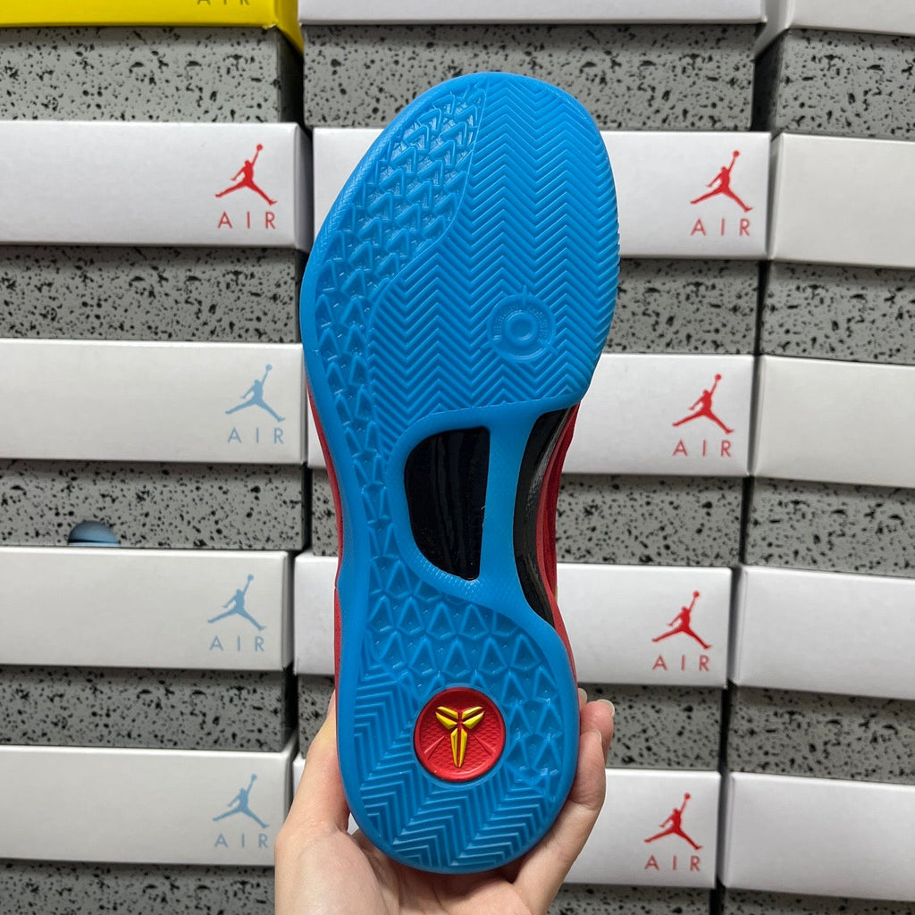Blue rubber outsole with traction pattern and circular logo.