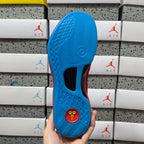 Blue rubber outsole with traction pattern and circular logo.