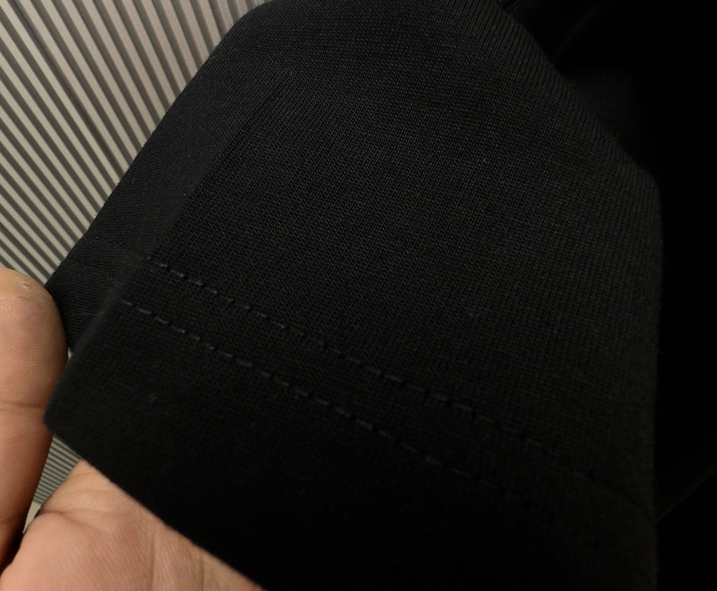Black T-shirt fabric and hem stitching detail