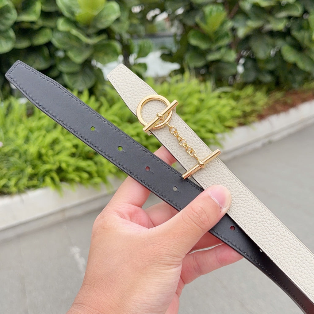 Hermes belt set with cream and dark straps, both with gold-tone buckles