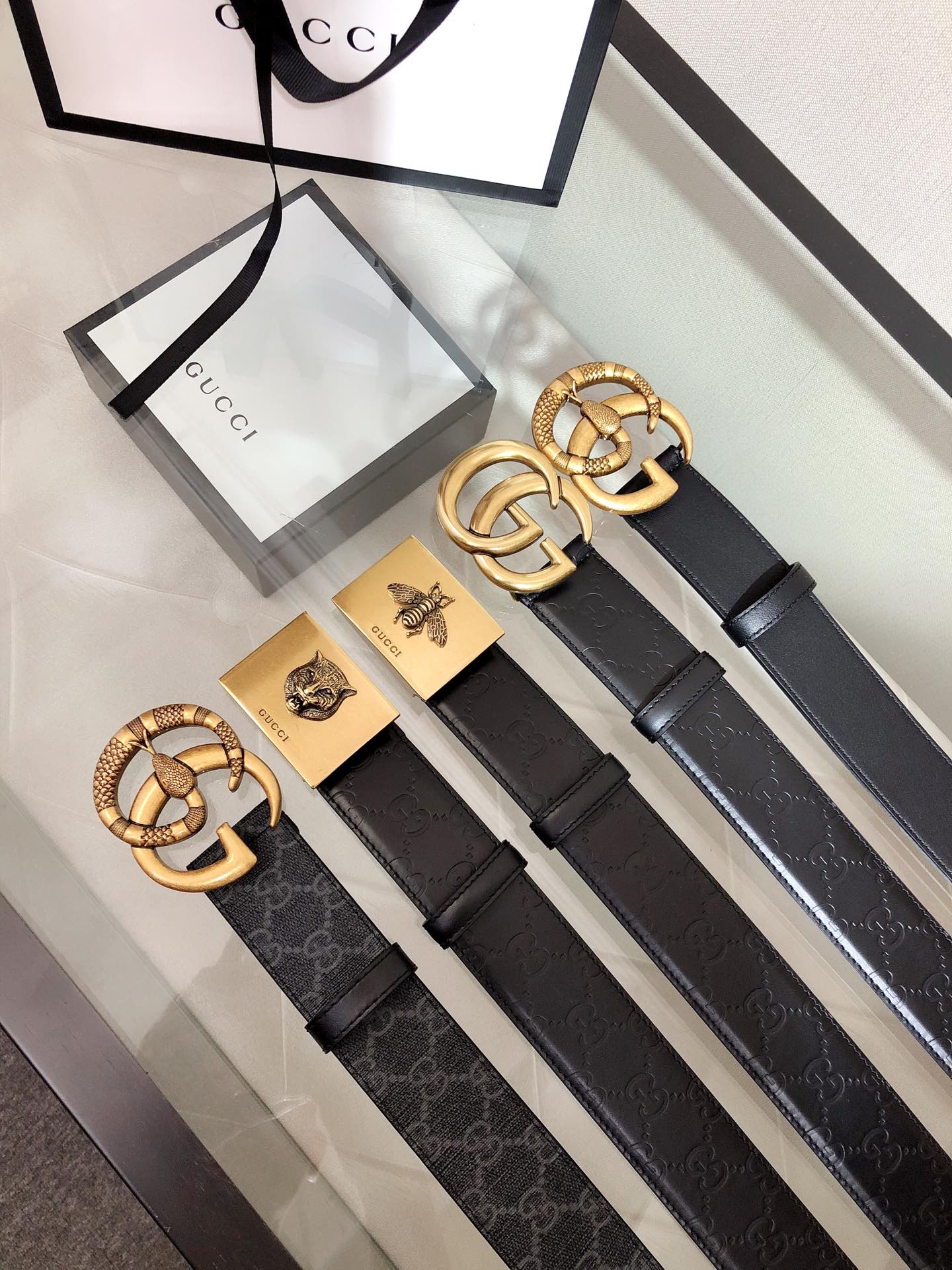 Gucci belt with black leather strap and gold interlocking G buckle