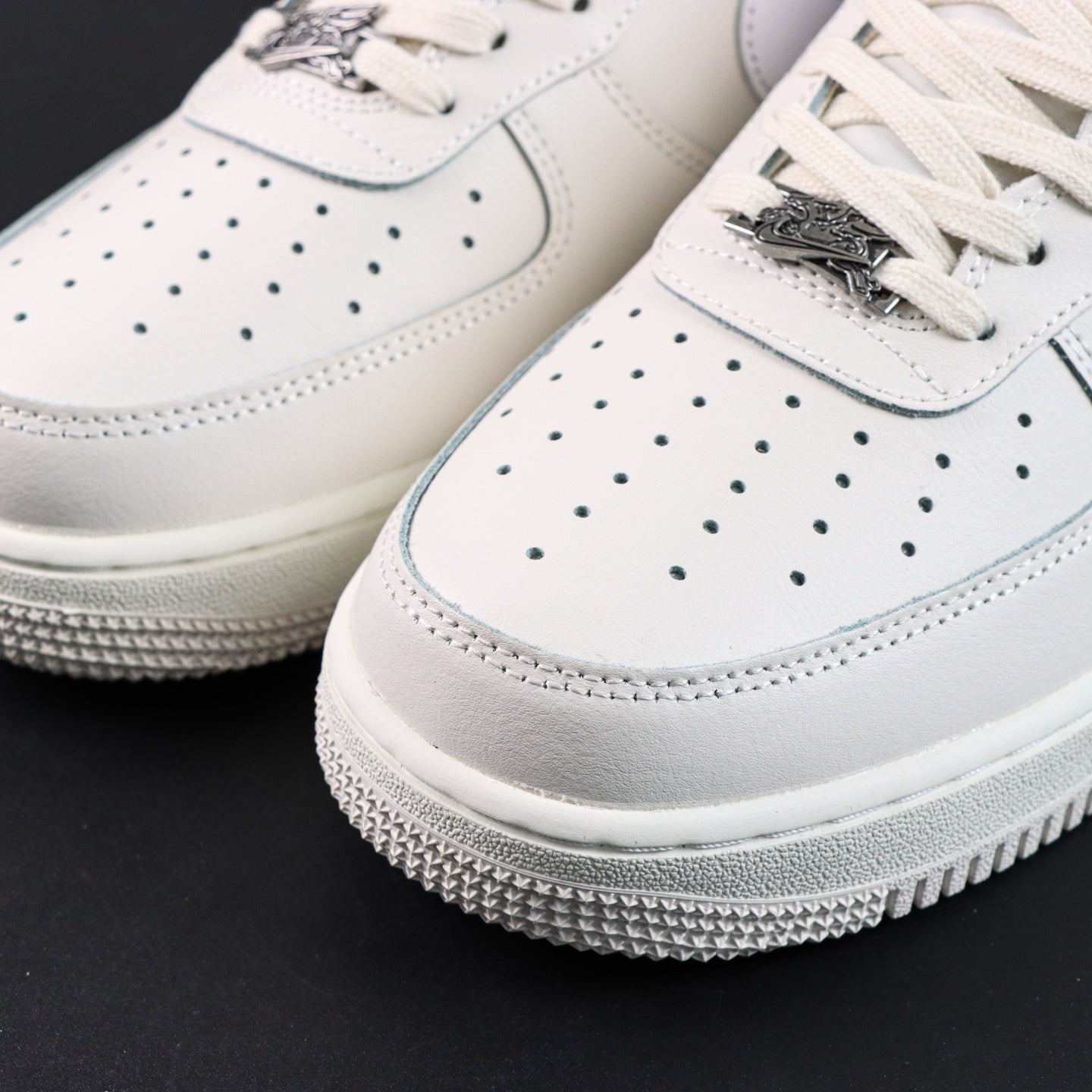 White Air Force 1 toe cap with perforations, lace eyelets, and textured overlay