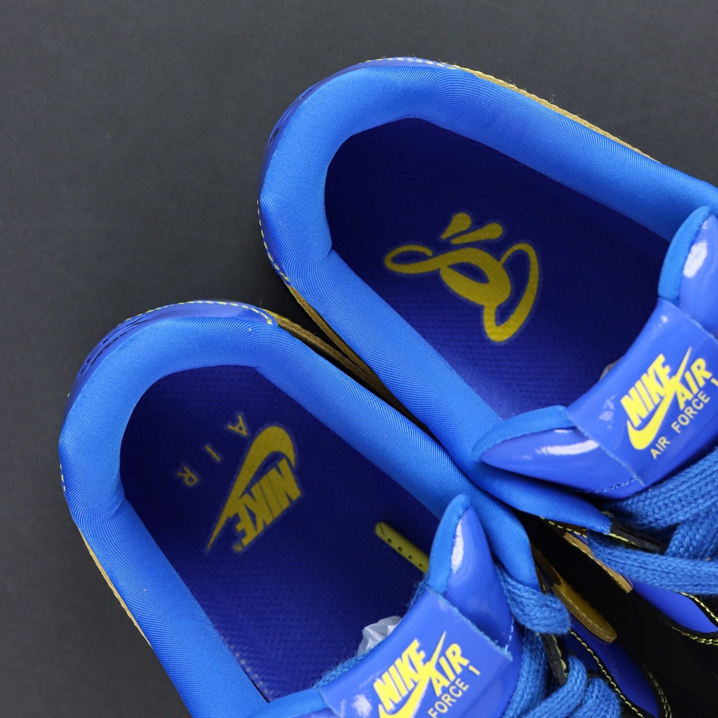 Nike Air Force 1 low-top sneakers; blue interior lining with Nike Air Force text.