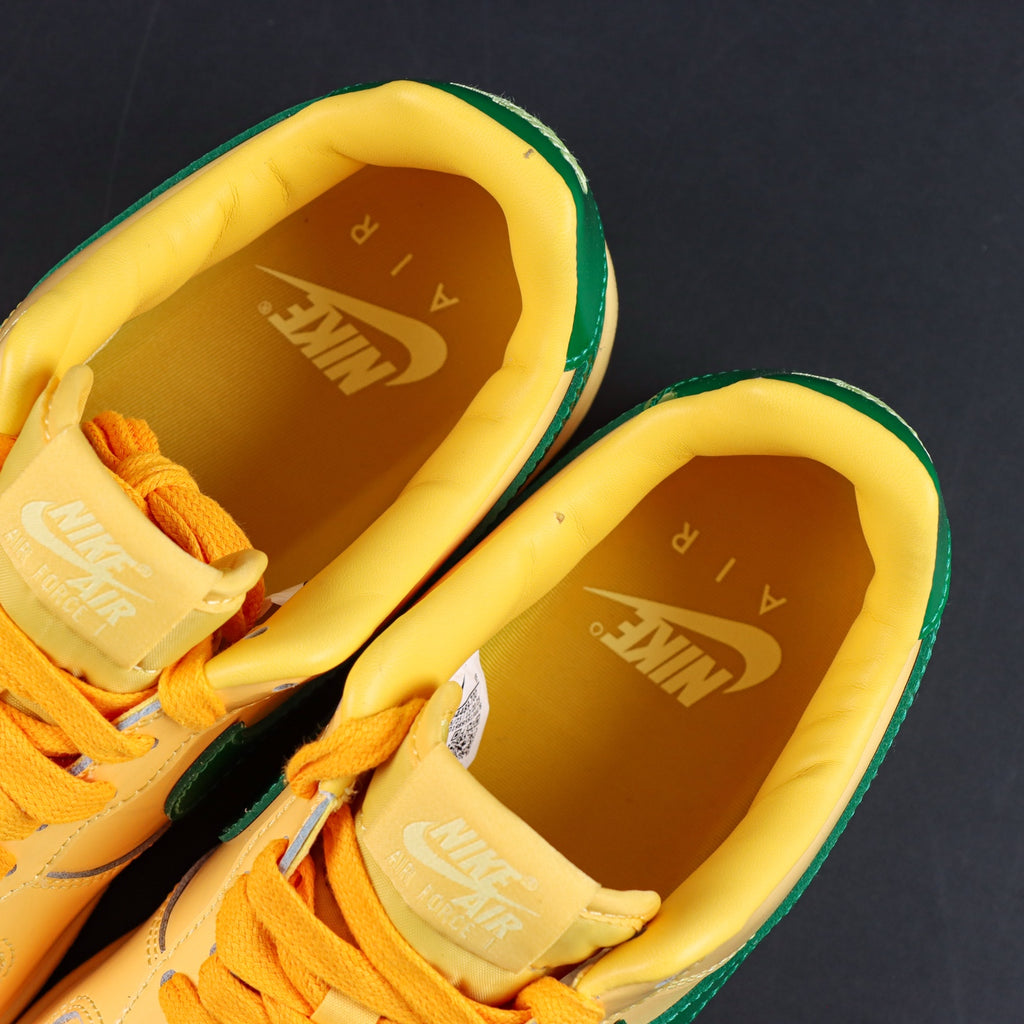 Nike Air Force 1 sneakers, yellow interior lining with green trim