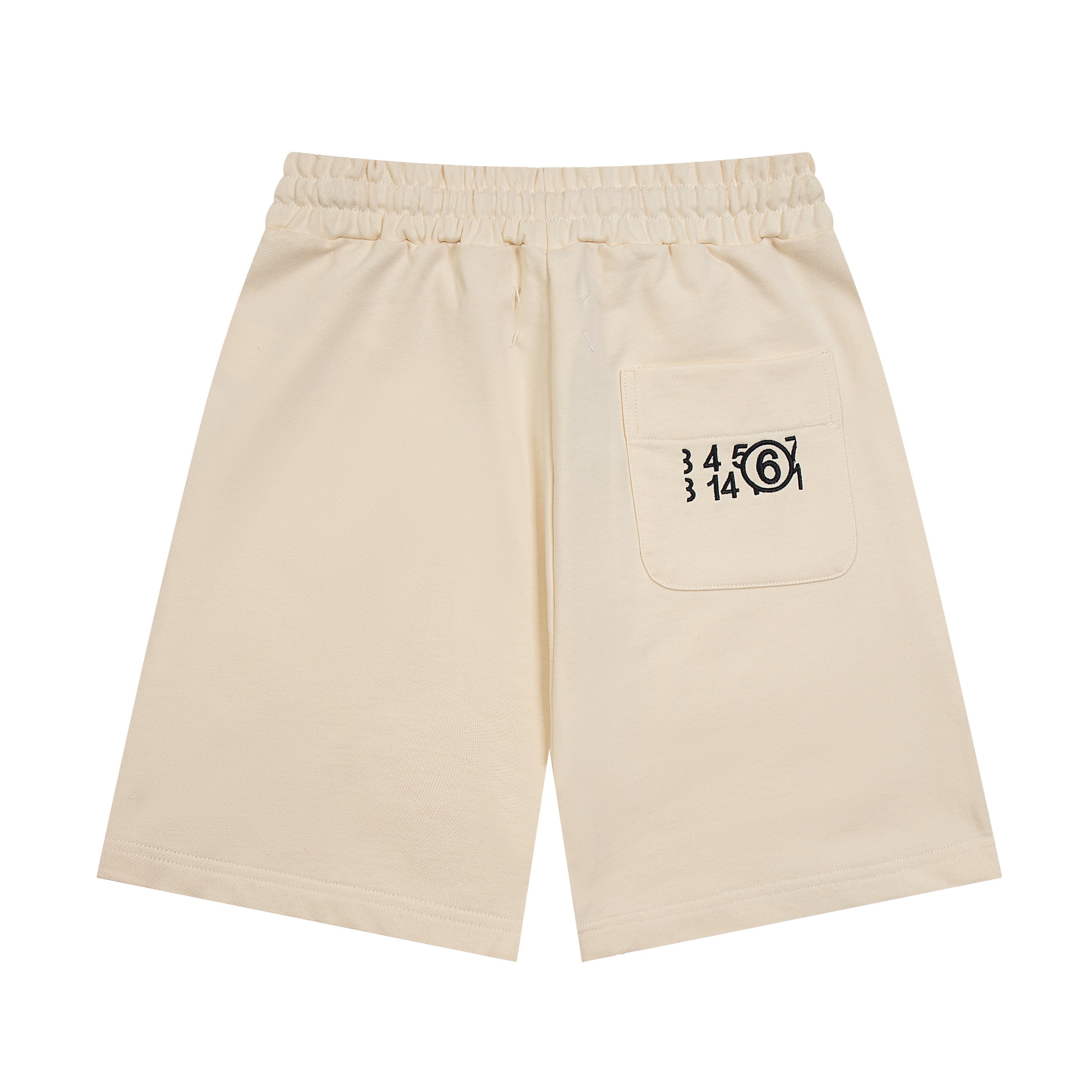 Light beige Maison Margiela shorts with drawstring and logo graphic on front pocket.