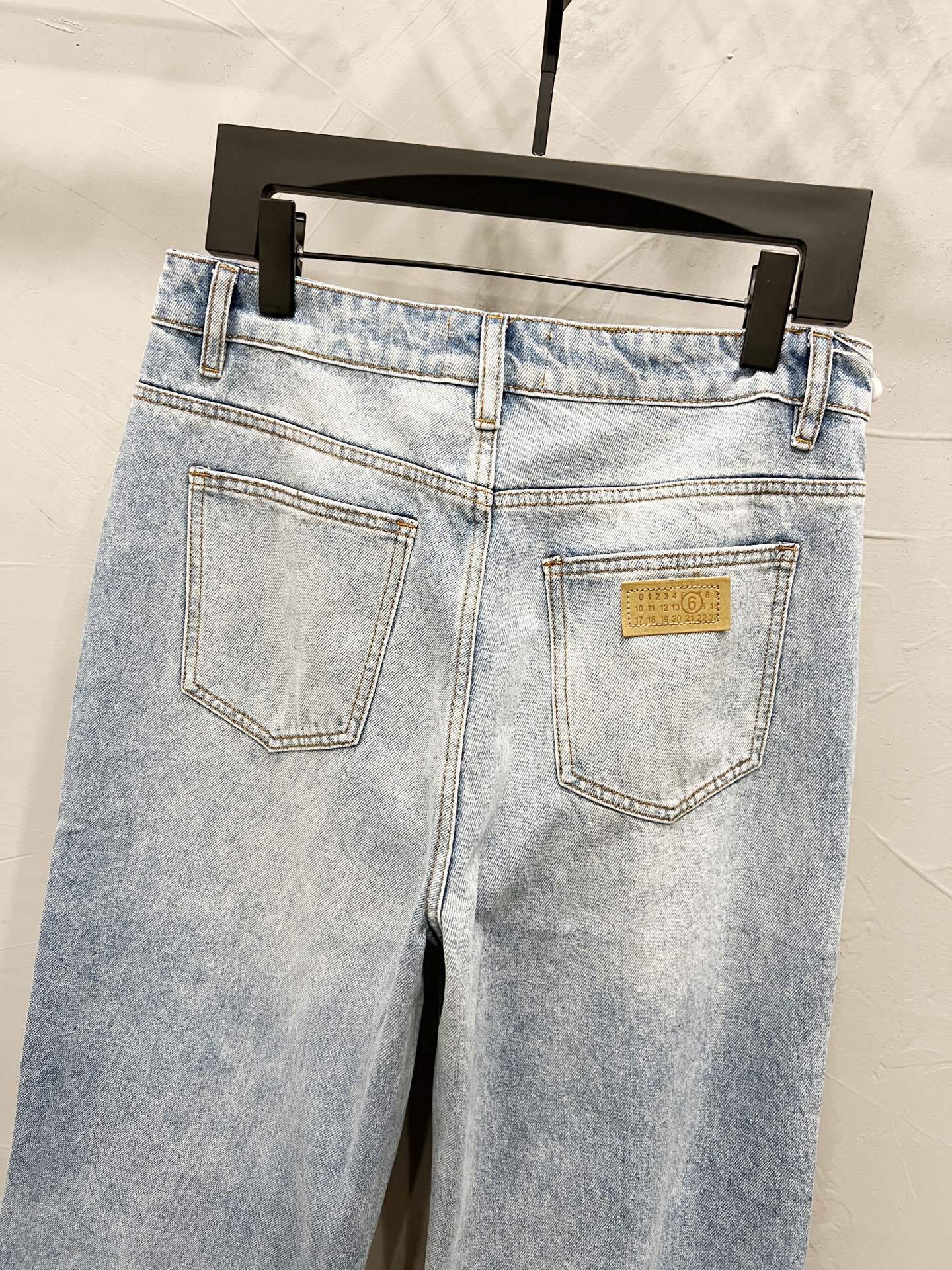 Maison Margiela denim jeans back view, light wash with two pockets and yellow logo label
