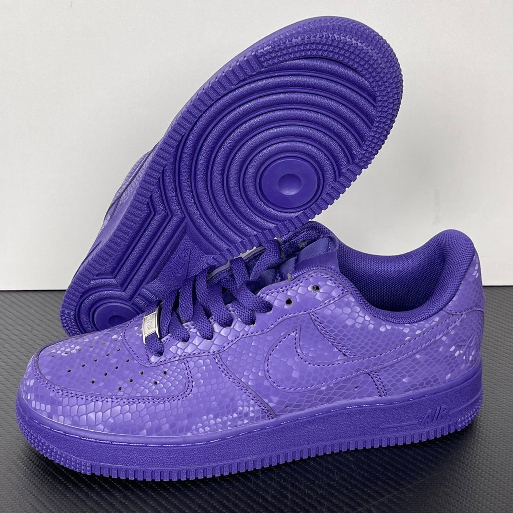 Purple low-top sneakers with lace-up closure and treaded outsole view