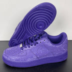 Purple low-top sneakers with lace-up closure and treaded outsole view