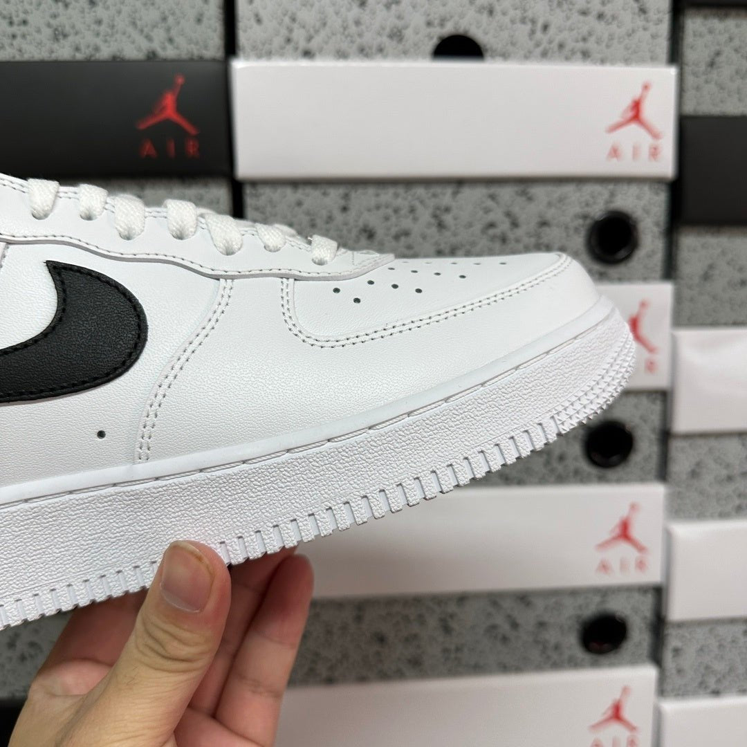 White sneaker side with black swoosh and textured white sole edge, side close-up