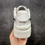 White sneaker heel view with embossed AMBUSH text on the midsole